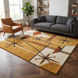 May include: A rectangular area rug featuring a geometric pattern in mustard yellow, cream, and burnt orange. The design includes black starburst motifs, thin black lines, and solid shapes, creating a structured composition on a textured surface.