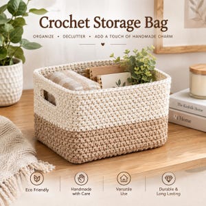 May include: A rectangular crochet storage bag featuring a two-tone design with a cream-colored top section and a tan-colored bottom section. The basket includes integrated side handles and contains a small notebook and a green plant inside.