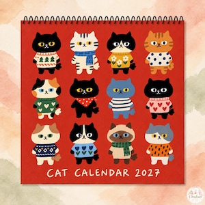 May include: A square wall calendar for 2027 with a red background featuring twelve illustrated cats wearing various sweaters and accessories. The text CAT CALENDAR 2027 is printed in white at the bottom. The calendar is bound with a black spiral wire.