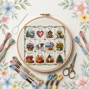 Peut inclure: Un tambour à broder en bois rond contenant un panneau en tissu avec un calendrier des douze mois. Chaque mois présente une illustration saisonnière et son nom. Le tambour est entouré d'échevettes de fil à broder, d'une aiguille et de ciseaux.