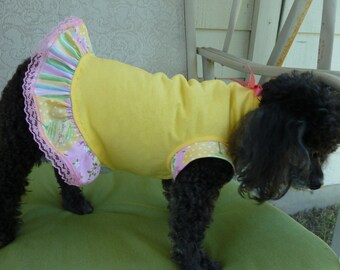 Dog Clothes, Puppy Dress in a Bright Yellow Bodice with short sleeves and a frilly ruffle in a Spring Motif and a Hot Pink Bow.