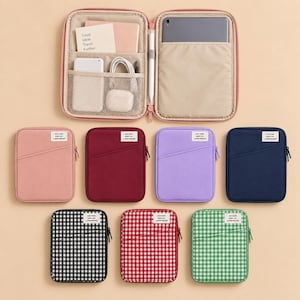 May include: A collection of rectangular zipped tech organisers in solid pink, maroon, purple, navy, and gingham patterns in black, red, and green. The open organiser reveals internal mesh pockets, a tablet sleeve, and a stylus holder with a card.