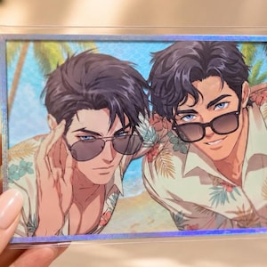 May include: A rectangular holographic print featuring an anime-style illustration of two individuals with dark hair wearing sunglasses and tropical floral shirts. The background depicts a sunny beach scene with palm trees under a bright blue sky.