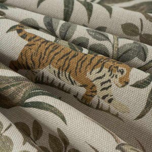 May include: Close-up of a fabric with a repeating pattern of tigers and foliage. The tigers are brown and black, and the leaves are green and gray. The fabric has a neutral background.