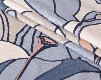 May include: A folded textile featuring a repeating graphic pattern of stylized botanical elements. The design consists of dark blue outlines on a background of muted light blue, cream, and soft peach tones, creating a layered visual effect.