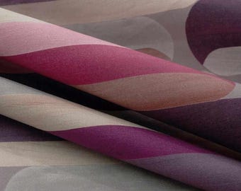 May include: A textile fabric featuring a repeating pattern of large, smooth, undulating waves in shades of deep purple, magenta, soft pink, and muted beige. The material has a subtle, fine-grained texture visible across the curved folds.