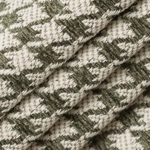 May include: Close-up of a green and white fabric with a houndstooth pattern. The fabric is woven with a textured surface.