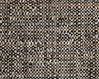 May include: A tightly woven textile fabric featuring a multi-colored pattern of cream, dark brown, and charcoal gray threads. The weave creates a dense, textured grid appearance with alternating vertical and horizontal yarn strands.