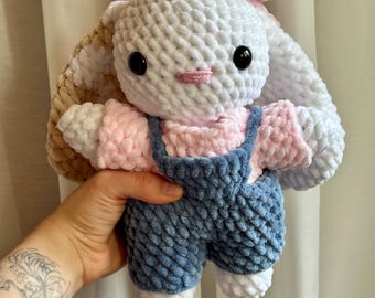 Handmade, crocheted bunny with a cute bow and overalls