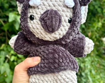 Handmade, crocheted koala or rabbit plush toy in a bat hoodie
