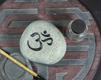 Ohm engraved stone