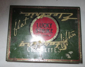 Lucky Strike tin box,, flat fifties cigarettes,  very scratched..  kind of ruff  shape......