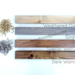 May include: Four rectangular wooden boards in Weathered Oak, Gray, Special Walnut, and Dark Walnut finishes, accompanied by two piles of metal screw hooks in gold and silver tones, with the text Weathered Oak, Gray, Special Walnut, and Dark Walnut.