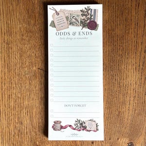 May include: A vertical notepad featuring the text ODDS & ENDS and little things to remember at the top. The design includes a tag, a bird stamp, and a wax seal. Below are lined checkboxes, the text DON'T FORGET, and a spool of thread at the bottom.