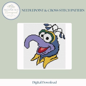 May include: A needlepoint and cross stitch pattern featuring a pixelated illustration of a blue character with a long purple nose, a red mouth, and a yellow collar. The design includes the text SECOND ACT REIMAGINED CREATIVE CO. and DIGITAL DOWNLOAD.