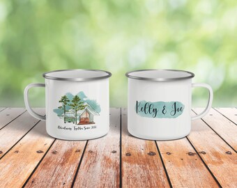 May include: Two white enamel camping mugs with silver rims. One mug features a watercolor illustration of a camper van, tent, and trees with the text "Adventuring Together Since 2016". The other mug has the text "Kelly & Joe" in black script with a blue watercolor background.