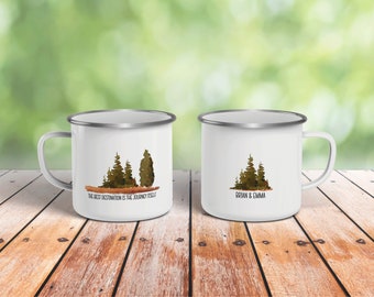 May include: Two white enamel mugs with a silver rim. One mug has a watercolor image of trees and the text "The best destination is the journey itself". The other mug has a watercolor image of trees and the text "Brian & Emma".