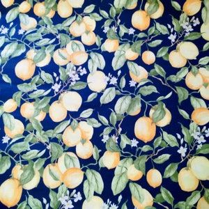 May include: A navy blue fabric with a repeating pattern of yellow lemons and green leaves. The lemons are clustered together on branches with white blossoms.