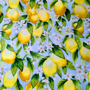 May include: A blue background with a repeating pattern of yellow lemons and white flowers. The lemons are arranged in a random pattern and are surrounded by green leaves.