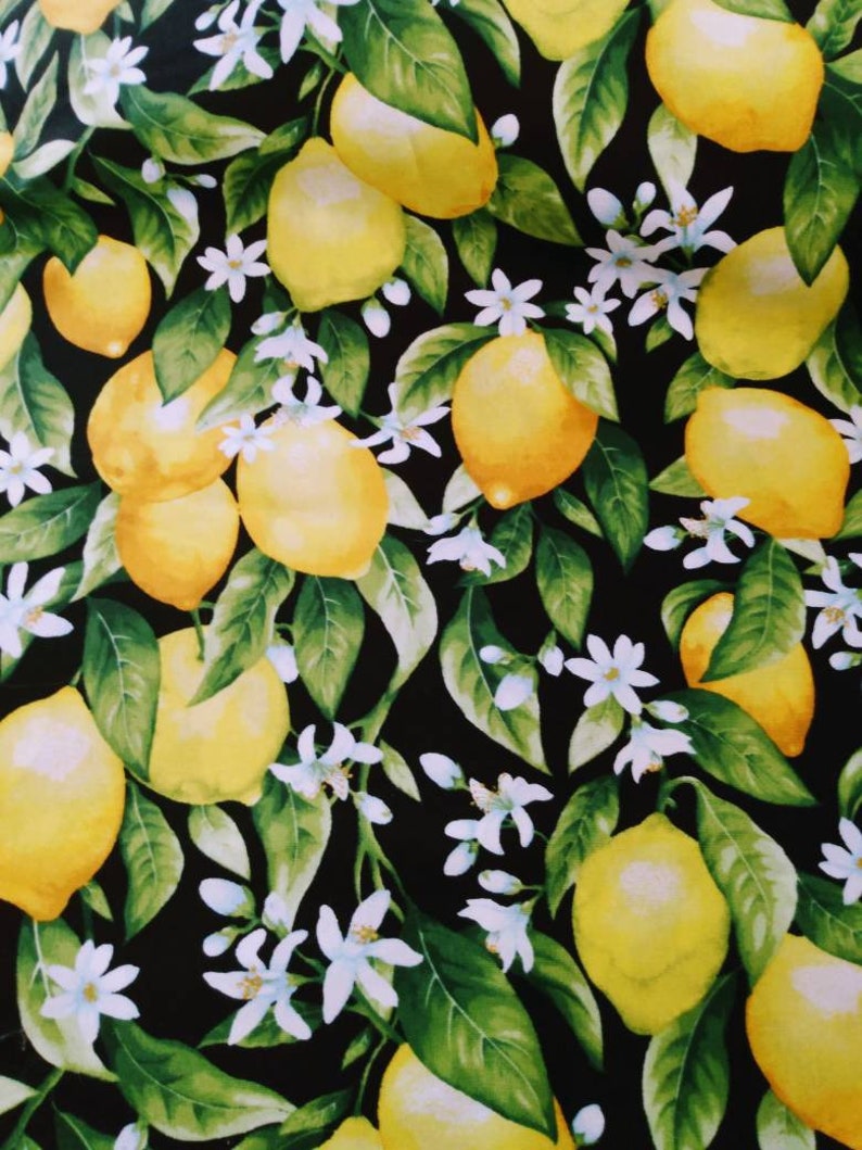 May include: A black background with a repeating pattern of yellow lemons and white blossoms. The lemons are arranged in a random pattern and are surrounded by green leaves.