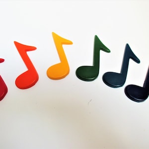 May include: Seven wooden musical notes in a rainbow of colours, red, orange, yellow, green, blue, indigo and violet.