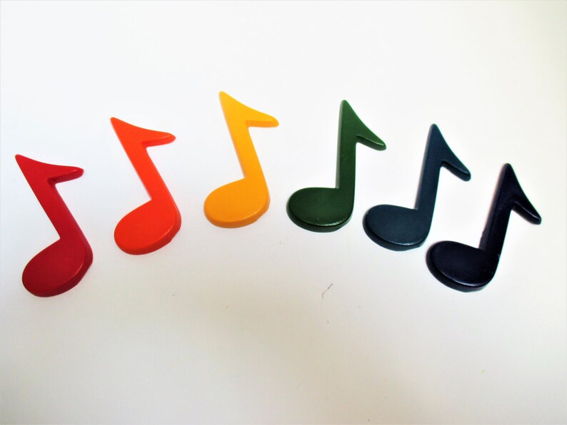 May include: Seven wooden musical notes in a rainbow of colours, red, orange, yellow, green, blue, indigo and violet.