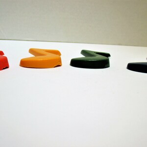 May include: Four plastic musical note shapes in red, orange, green, and black.