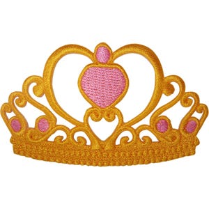 May include: A crown-shaped embroidered patch featuring a vibrant gold thread border and intricate scrollwork. The design includes a central pink heart-shaped element and four smaller pink circular accents integrated into the golden filigree pattern.