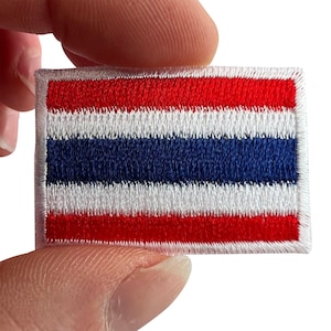 May include: A rectangular embroidered patch featuring the national flag of Thailand. The design consists of five horizontal stripes in the order of red, white, blue, white, and red, with a white stitched border surrounding the entire rectangular shape.