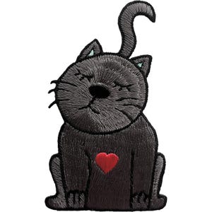 May include: An embroidered patch featuring a dark gray cat with a rounded head, closed eyes, and a long, curved tail. The cat is sitting in a forward-facing position and has a small, bright red heart stitched onto the center of its chest.