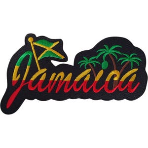 May include: A black embroidered patch featuring the word Jamaica in a cursive script with a gradient of green, yellow, and red thread. The design includes a small Jamaican flag on a gold pole and three green palm trees on a black background.