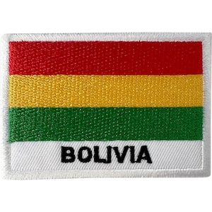 May include: A rectangular embroidered patch featuring the flag of Bolivia with horizontal stripes of red, yellow, and green. The bottom white section includes the word BOLIVIA stitched in bold black capital letters with a white border edge.