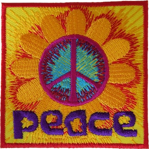 Può includere: Una toppa ricamata quadrata con un simbolo della pace centrale blu e magenta, circondato da petali di fiori arancioni e gialli. La parola peace è ricamata in lettere viola nella parte inferiore su uno sfondo giallo vivo con bordo rosso.