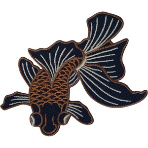 May include: An embroidered patch shaped like a goldfish with a dark navy blue body and fins. The fish features a copper-coloured scale pattern on its head and back, with white linear details accentuating the flowing fins and tail structure.