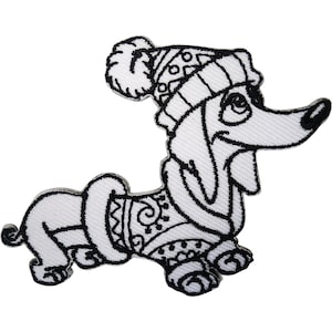 May include: An embroidered patch featuring a black and white line art illustration of a dachshund dog. The dog is wearing a knit-style winter hat with a pom-pom and a patterned sweater. The design uses bold black outlines on a white fabric base.
