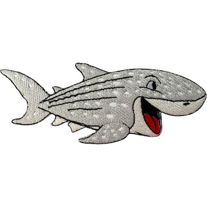 May include: An embroidered patch shaped like a gray whale shark with white spots and dark gray horizontal stripes. The shark has a wide, open mouth revealing a bright red tongue and interior, with a black outline defining its cartoonish features.