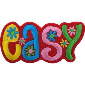 May include: An embroidered patch featuring the word "easy" in colourful, rounded letters. The "e" is yellow, the "a" is blue, the "s" is pink, and the "y" is green. Each letter is decorated with small, multi-coloured flower embroidery.