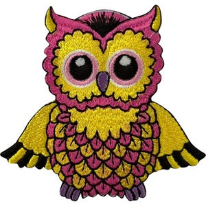 May include: An embroidered owl patch featuring vibrant pink and yellow thread. The owl has large, round eyes with pink irises and black pupils, a small purple beak, and black-tipped wings. The design is detailed with textured stitching throughout.