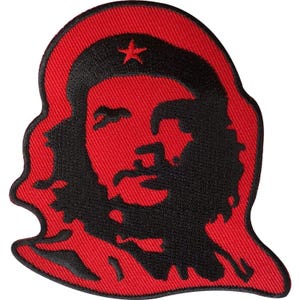 May include: A fabric patch featuring a black embroidered silhouette of a person wearing a beret with a star, set against a vibrant red background. The design is outlined in black thread, creating a high-contrast graphic representation of a face.
