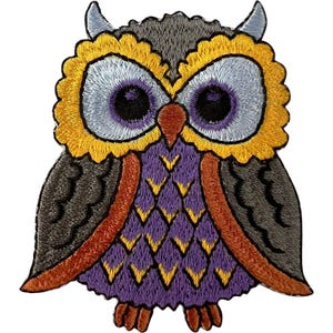 May include: An embroidered owl patch featuring a grey head with two small tufts, large light blue eyes with dark purple irises, and a bright yellow scalloped border. The body has purple feathers with yellow accents, grey wings, and orange feet.