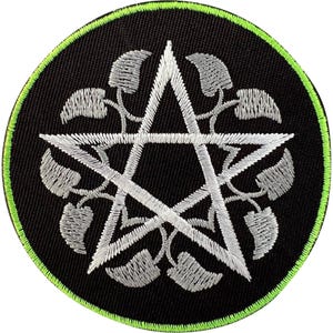 May include: A circular embroidered patch featuring a black background with a bright lime green stitched border. In the centre, a silver-white pentagram is surrounded by a symmetrical pattern of small, stylised silver-white leaves.