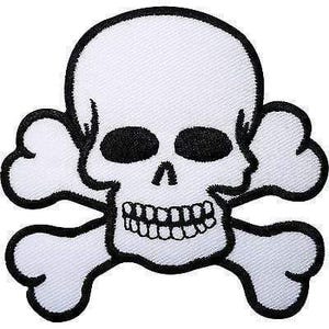 May include: A white embroidered patch featuring a black-outlined skull and crossbones design. The skull has black eye sockets and a detailed set of teeth, while the crossbones extend behind the cranium, all bordered by a thick black thread.