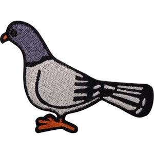 Könnte beinhalten: Ein gestickter Aufbügler in Form einer Taube. Der Vogel hat einen hellgrauen Körper, einen dunkleren grauen Hals und eine schwarze Umrandung. Er besitzt orangefarbene Füße und einen kleinen orangefarbenen Schnabel. Das Design zeigt schwarze Details.