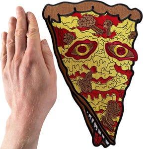 May include: A large embroidered patch shaped like a slice of pizza with a brown crust, red sauce, and yellow cheese. The design features two realistic human eyes embedded in the cheese, along with several brown brain-like shapes as toppings.