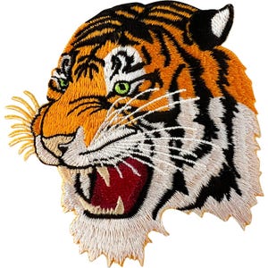 May include: An embroidered patch featuring the head of a tiger in profile. The design displays vibrant orange fur with black stripes, white fur around the muzzle and neck, bright green eyes, and an open mouth revealing sharp teeth and a red tongue.