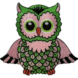 May include: An embroidered patch shaped like an owl with large black eyes, a small orange beak, and a body featuring a pattern of green and light pink feathers. The owl has green tufted ears, pink facial discs, and outstretched wings with black tips.