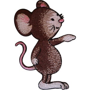 May include: An embroidered patch featuring a brown mouse standing on its hind legs. The mouse has large ears with pink centers, a small pink nose, and a long pink tail. The fur is rendered in shades of brown and tan thread, with white paws.