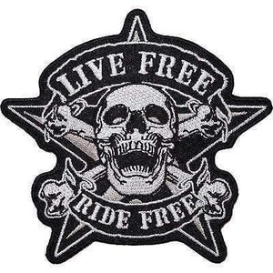 May include: A black and white embroidered patch featuring a central skull design overlaid on a five-pointed star. Crossed bones are positioned behind the skull. The text LIVE FREE is arched above the skull, and RIDE FREE is arched below.