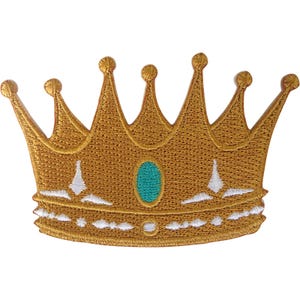May include: A gold embroidered patch in the shape of a crown with five points topped by small spheres. The crown features a central oval teal accent and white stitched detailing along the base and lower band, creating a textured appearance.