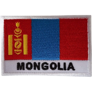 May include: A rectangular embroidered patch featuring the flag of Mongolia with vertical red, blue, and red stripes. The left red stripe displays the yellow Soyombo symbol. A white horizontal bar at the bottom contains the black text MONGOLIA.